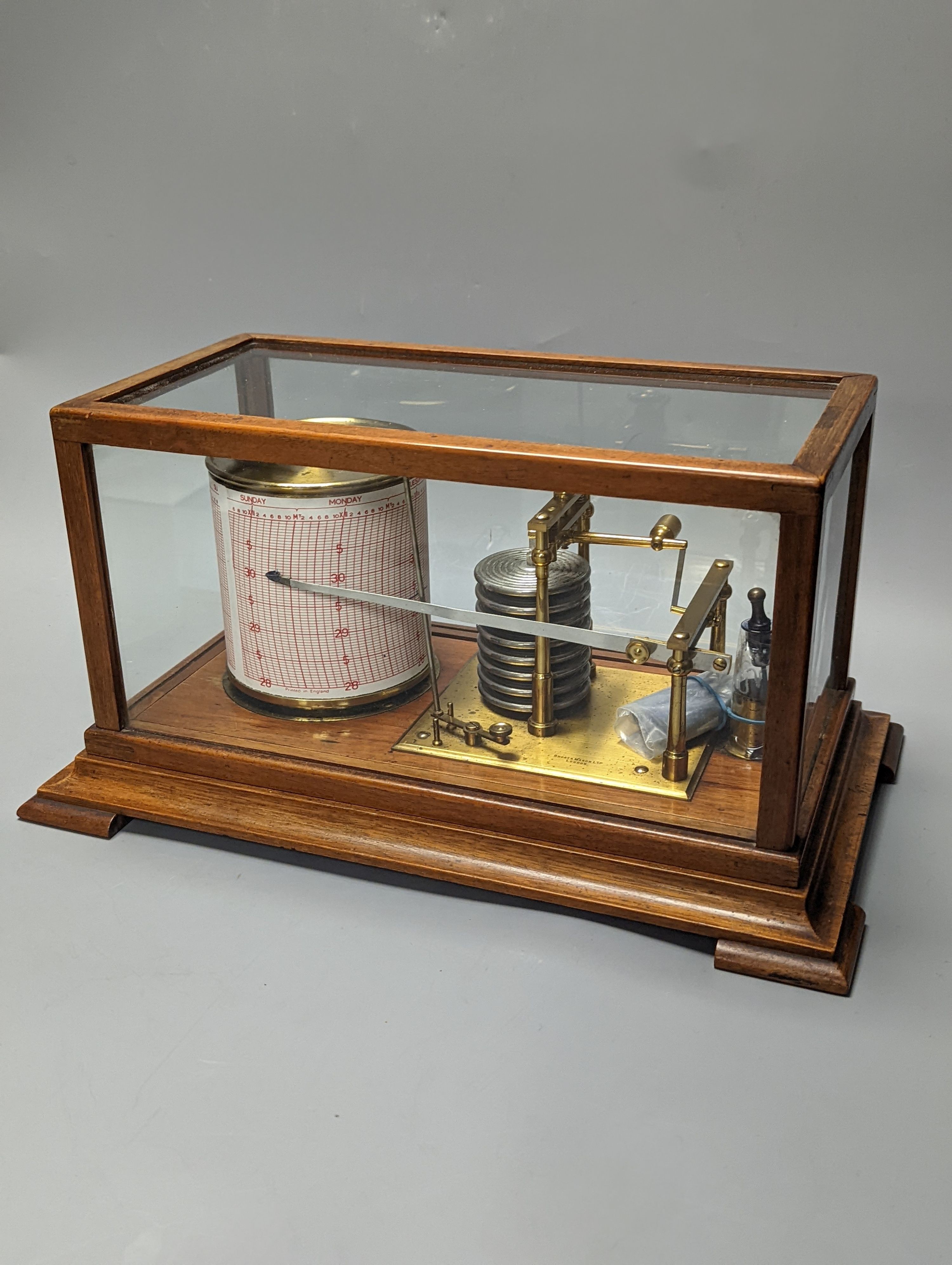 A Short & Mason oak cased barograph with spare graph paper